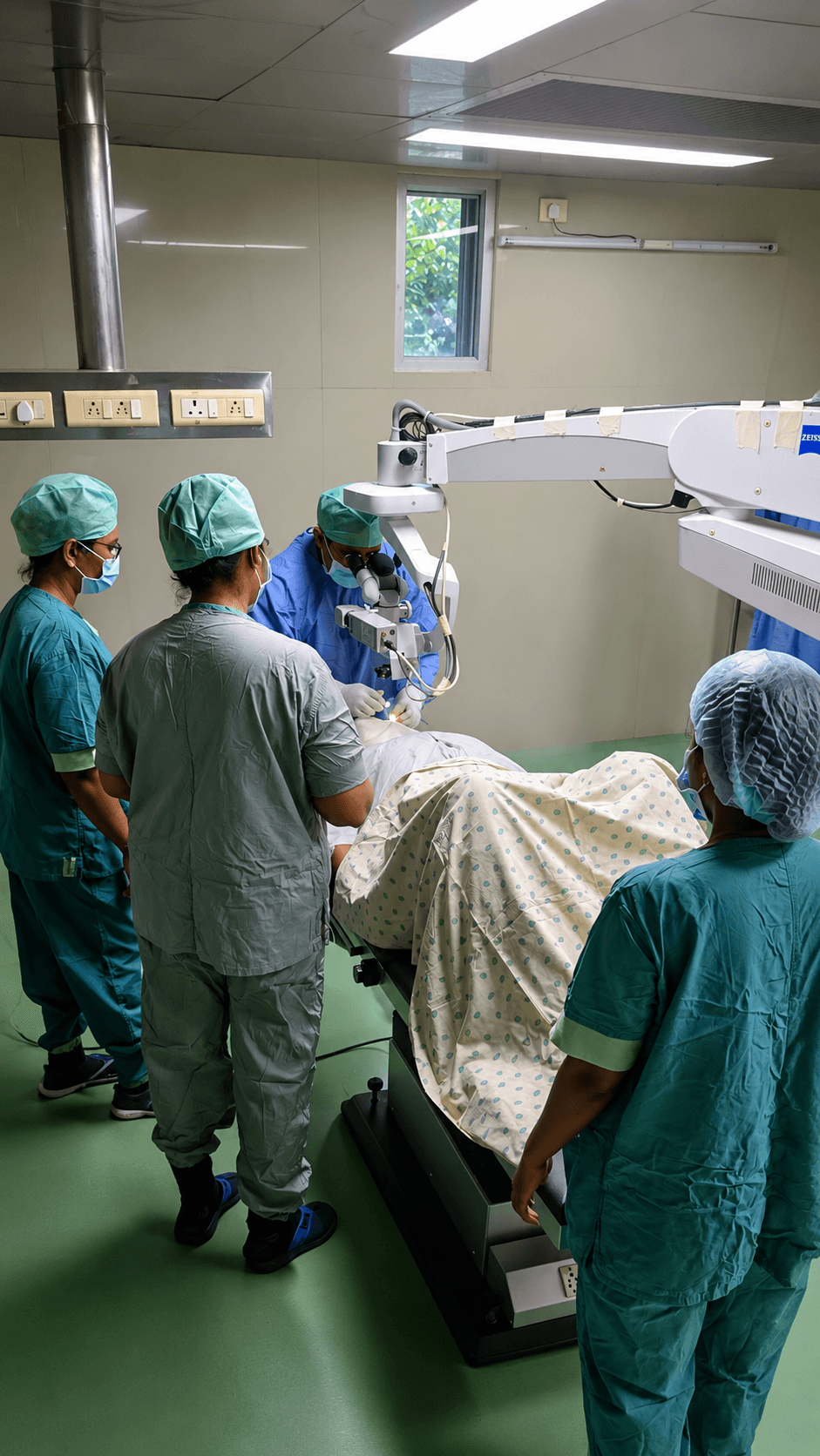 Eye surgery in progress: surgical team using an operating microscope in a sterile theatre